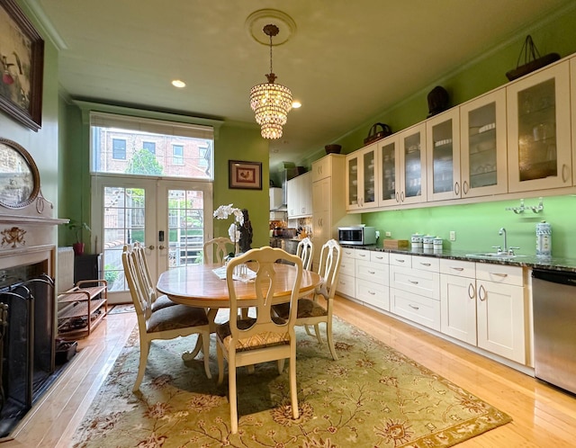 229 W 138th St, New York Manhattan, NY 10030 - dining area with light wood-style flooring, french doors, recessed lighting, a chandelier, and a fireplace