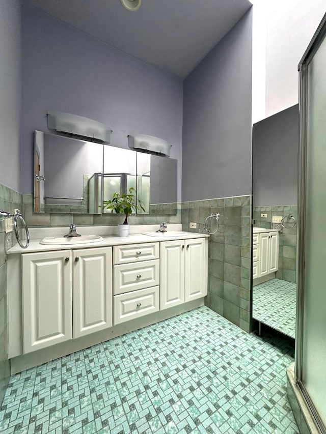 229 W 138th St, New York Manhattan, NY 10030 - full bathroom featuring tile walls, double vanity, and a wainscoted wall
