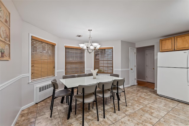 12 Horizon Ct Unit 103, Monsey, NY 10952 - dining area with a chandelier, radiator, light tile patterned floors, and baseboards