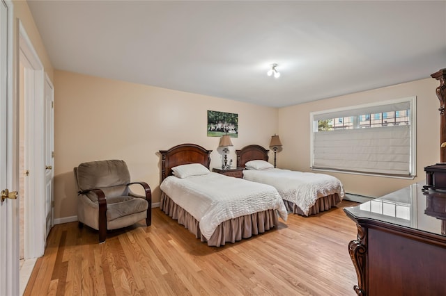 12 Horizon Ct Unit 103, Monsey, NY 10952 - bedroom featuring baseboard heating, light wood-type flooring, and baseboards