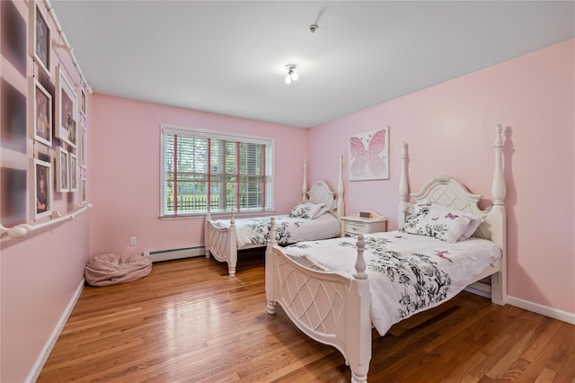 12 Horizon Ct Unit 103, Monsey, NY 10952 - bedroom with a baseboard radiator, light wood-type flooring, and baseboards