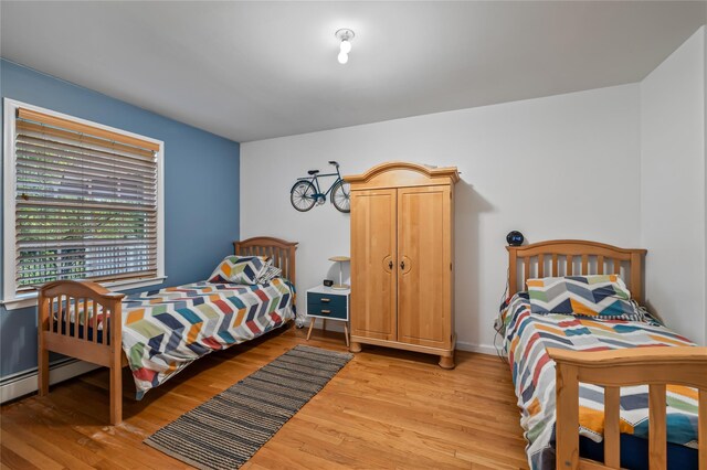 12 Horizon Ct Unit 103, Monsey, NY 10952 - bedroom featuring light wood-style flooring, a baseboard radiator, and baseboards