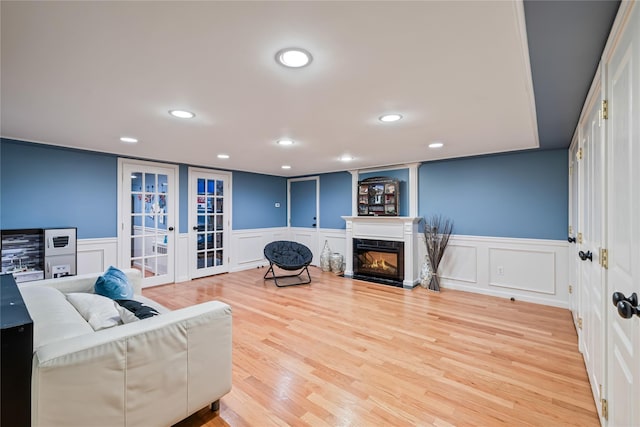 12 Horizon Ct Unit 103, Monsey, NY 10952 - living area featuring french doors, recessed lighting, a decorative wall, wainscoting, and a glass covered fireplace