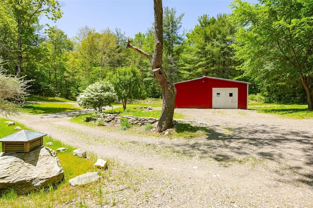 detached garage with gravel driveway