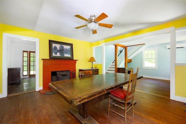 office space featuring a fireplace, hardwood / wood-style flooring, healthy amount of natural light, ceiling fan, and vaulted ceiling