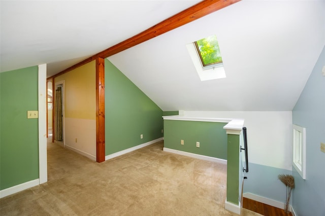 bonus room with a skylight, lofted ceiling, light colored carpet, and baseboards