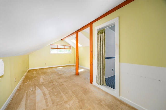 bonus room featuring lofted ceiling, light colored carpet, and baseboards