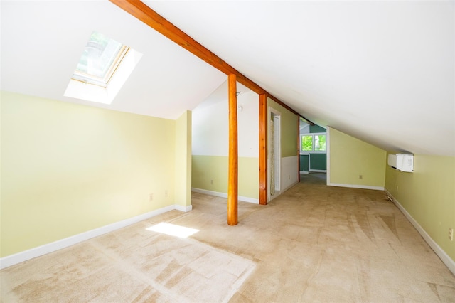 additional living space featuring a skylight, vaulted ceiling, light colored carpet, and baseboards