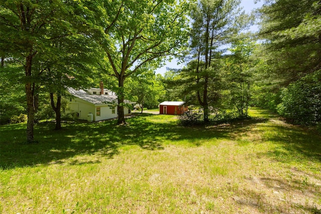 view of green lawn with an outbuilding