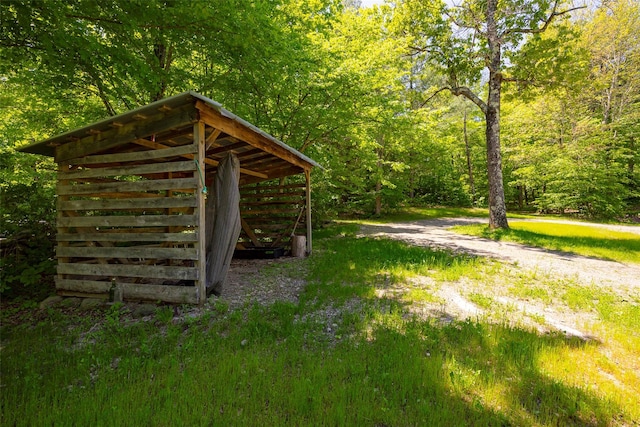 view of outdoor structure with a wooded view