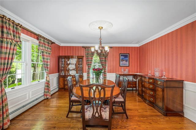 74 Eakins Rd, Manhasset, NY 11030 - dining room with a chandelier, ornamental molding, wood finished floors, baseboard heating, and wainscoting