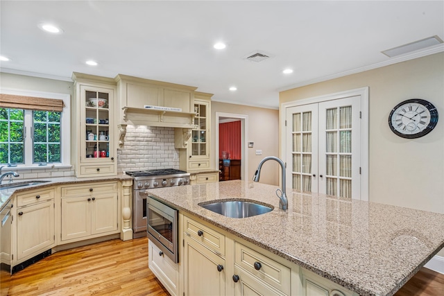 74 Eakins Rd, Manhasset, NY 11030 - kitchen featuring cream cabinets, stainless steel appliances, ornamental molding, tasteful backsplash, and light wood finished floors