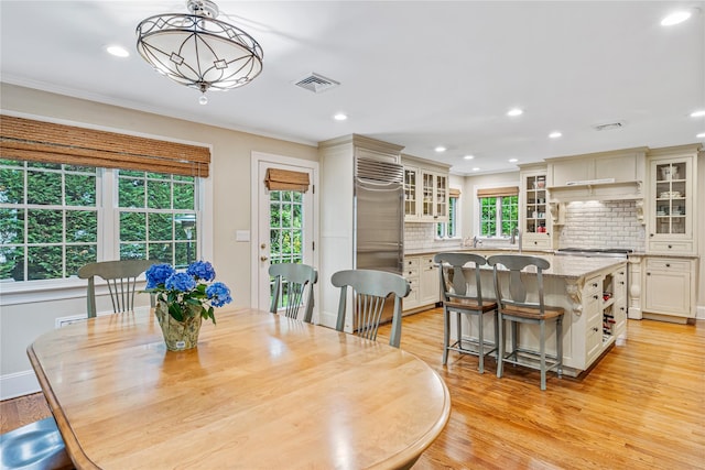 74 Eakins Rd, Manhasset, NY 11030 - dining area with light wood-type flooring, recessed lighting, and crown molding