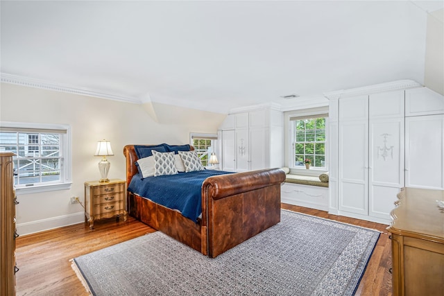 74 Eakins Rd, Manhasset, NY 11030 - bedroom with crown molding and light wood-style floors
