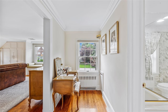 74 Eakins Rd, Manhasset, NY 11030 - dining room featuring radiator heating unit, crown molding, healthy amount of natural light, and wood finished floors