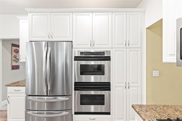 306 Mountain Rd, Pleasantville, NY 10570 - kitchen with stainless steel appliances, light stone counters, and white cabinets