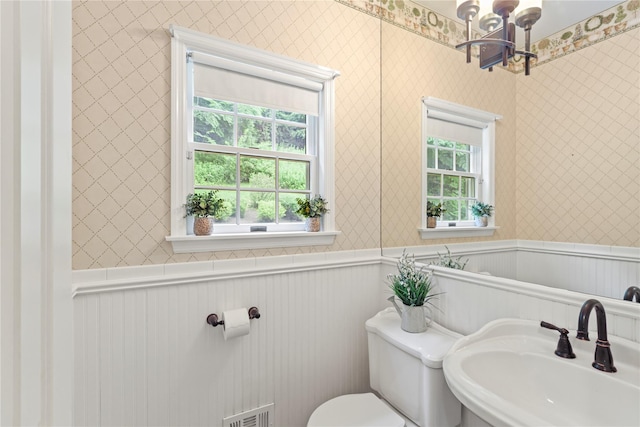 306 Mountain Rd, Pleasantville, NY 10570 - half bath with a chandelier, wallpapered walls, and a wainscoted wall
