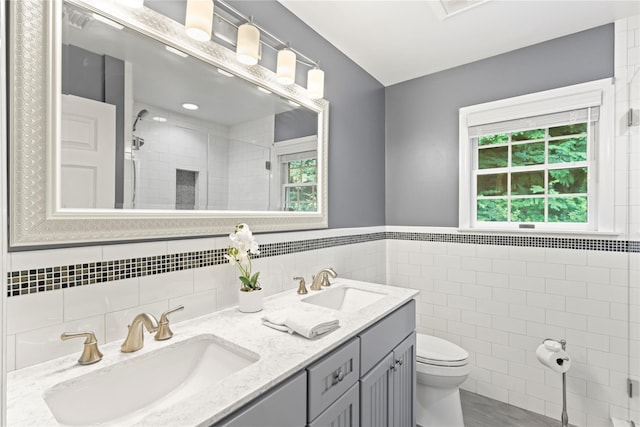 306 Mountain Rd, Pleasantville, NY 10570 - full bathroom featuring tile walls, a tile shower, double vanity, and wainscoting