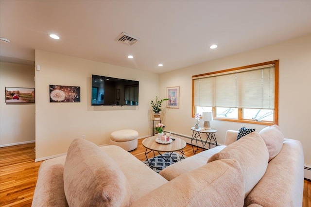 2083 Oliver Way, Merrick, NY 11566 - living area featuring baseboard heating, baseboards, wood finished floors, and recessed lighting