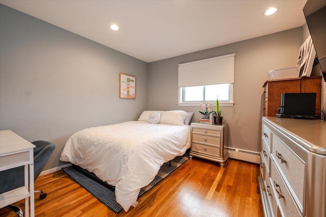 2083 Oliver Way, Merrick, NY 11566 - bedroom with a baseboard heating unit, wood finished floors, and recessed lighting