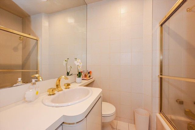 2083 Oliver Way, Merrick, NY 11566 - bathroom with tile walls, toilet, combined bath / shower with glass door, and vanity