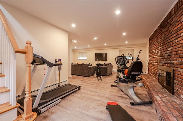 2083 Oliver Way, Merrick, NY 11566 - exercise room featuring a brick fireplace, recessed lighting, wood finished floors, a baseboard heating unit, and a baseboard radiator