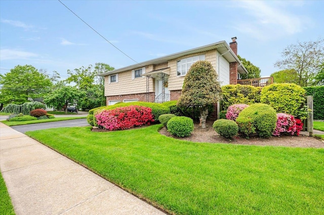 2083 Oliver Way, Merrick, NY 11566 - view of front of property with a chimney, a front yard, a garage, and driveway