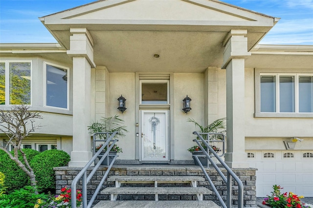 100 Mark Ln, Atlantic Beach, NY 11509 - doorway to property with stucco siding and a garage