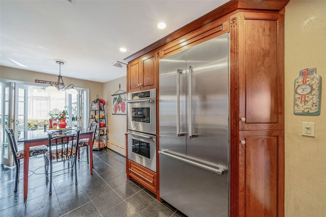100 Mark Ln, Atlantic Beach, NY 11509 - kitchen with stainless steel appliances, recessed lighting, brown cabinets, baseboards, and pendant lighting