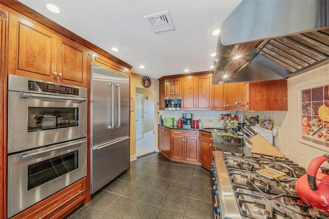 100 Mark Ln, Atlantic Beach, NY 11509 - kitchen with stainless steel appliances, premium range hood, recessed lighting, and brown cabinets