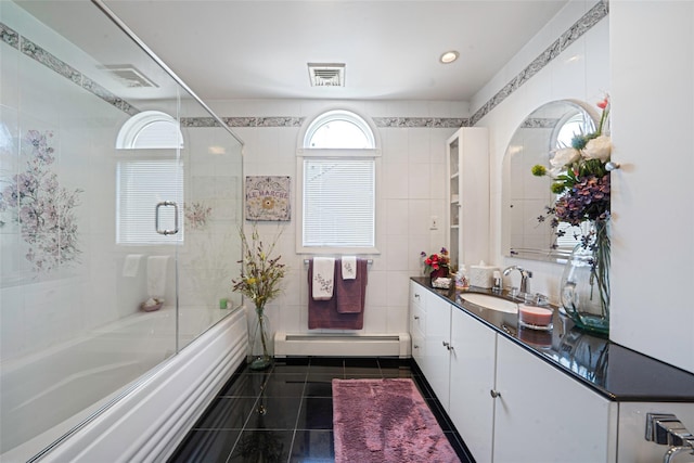 100 Mark Ln, Atlantic Beach, NY 11509 - full bathroom with baseboard heating, tile walls, vanity, tile patterned floors, and enclosed tub / shower combo