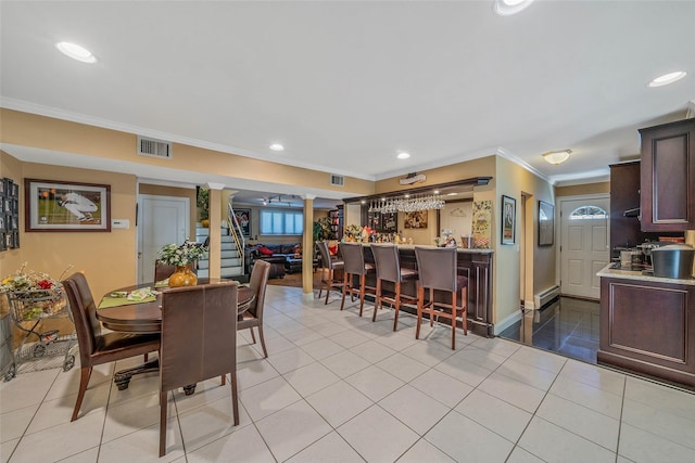 100 Mark Ln, Atlantic Beach, NY 11509 - dining area featuring decorative columns, ornamental molding, recessed lighting, bar area, and light tile patterned flooring