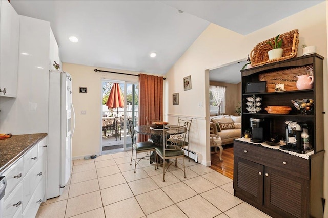 2406 Kayron Ln, North Bellmore, NY 11710 - dining space with lofted ceiling, plenty of natural light, light tile patterned floors, a baseboard radiator, and recessed lighting
