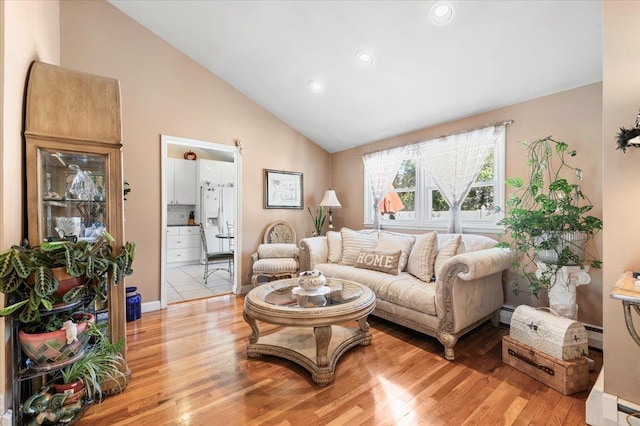 2406 Kayron Ln, North Bellmore, NY 11710 - living area featuring light wood-type flooring, high vaulted ceiling, recessed lighting, and baseboards