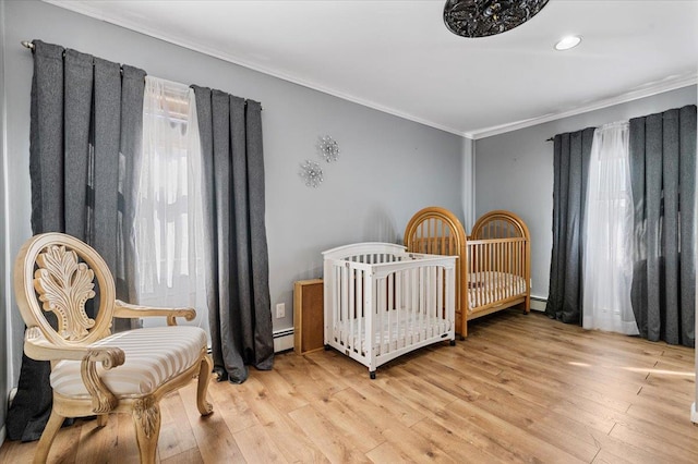 2406 Kayron Ln, North Bellmore, NY 11710 - bedroom featuring crown molding, wood finished floors, a baseboard heating unit, baseboard heating, and recessed lighting