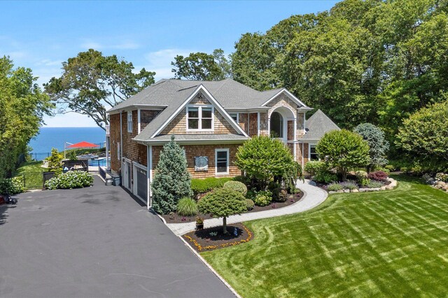 321 Sandpiper Dr, Riverhead, NY 11901 - shingle-style home featuring driveway, a water view, a garage, and a shingled roof