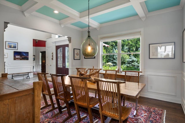 321 Sandpiper Dr, Riverhead, NY 11901 - dining area featuring coffered ceiling, beamed ceiling, a decorative wall, wood finished floors, and crown molding