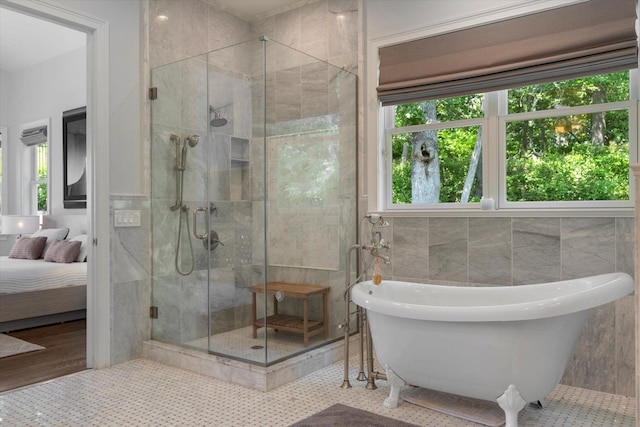 321 Sandpiper Dr, Riverhead, NY 11901 - ensuite bathroom featuring a freestanding tub, tile walls, a shower stall, healthy amount of natural light, and wood finished floors