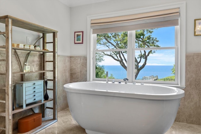 321 Sandpiper Dr, Riverhead, NY 11901 - bathroom with tile walls, a soaking tub, and a wainscoted wall