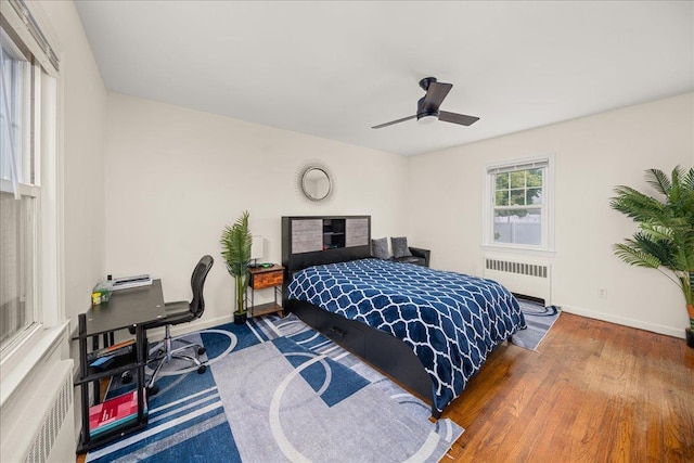 769 De Mott Ave, North Baldwin, NY 11510 - bedroom featuring radiator, baseboards, wood finished floors, and ceiling fan