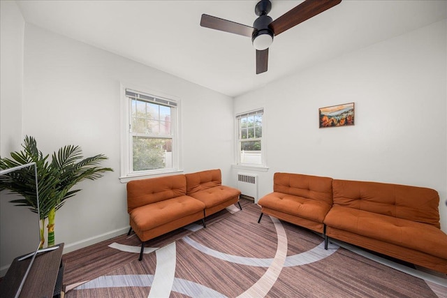 769 De Mott Ave, North Baldwin, NY 11510 - living area with radiator heating unit, baseboards, ceiling fan, and wood finished floors