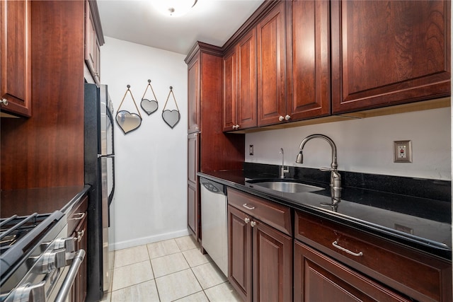 100 Lincoln Ave Unit 4B, Mineola, NY 11501 - kitchen with a sink, stainless steel appliances, light tile patterned flooring, dark stone countertops, and baseboards