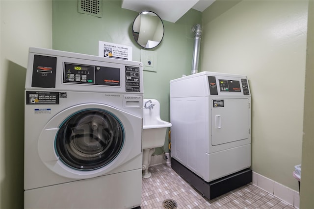 100 Lincoln Ave Unit 4B, Mineola, NY 11501 - shared laundry room with independent washer and dryer, tile patterned floors, and baseboards