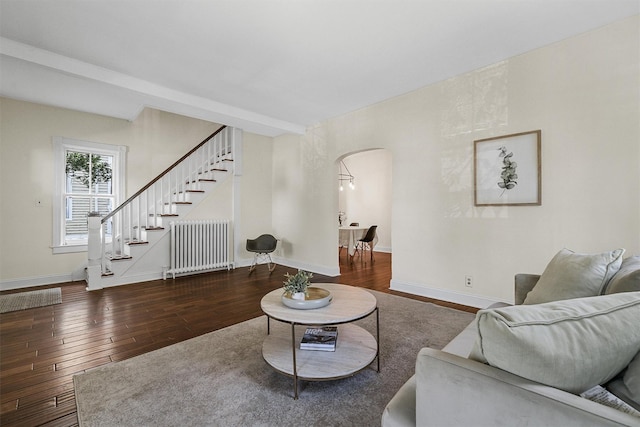 213 Walnut St, Peekskill, NY 10566 - living area featuring arched walkways, hardwood / wood-style floors, stairs, and radiator heating unit