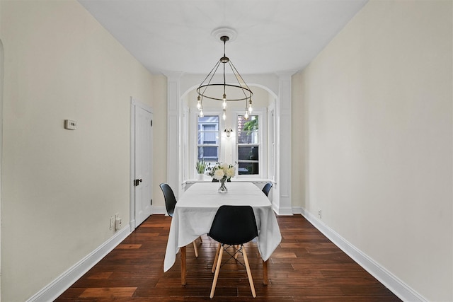 213 Walnut St, Peekskill, NY 10566 - dining room with decorative columns, dark wood-type flooring, baseboards, and arched walkways