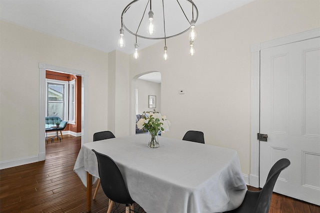 213 Walnut St, Peekskill, NY 10566 - dining space with arched walkways, dark wood-type flooring, and baseboards