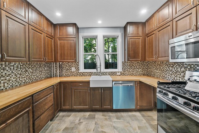 213 Walnut St, Peekskill, NY 10566 - kitchen with appliances with stainless steel finishes, butcher block countertops, a sink, backsplash, and recessed lighting