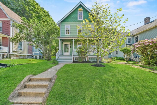 213 Walnut St, Peekskill, NY 10566 - victorian house featuring a porch and a front lawn