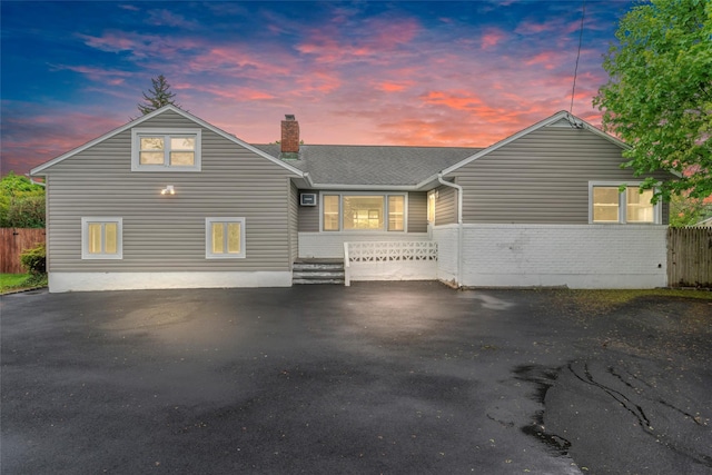 2600 Haff Ave, North Bellmore, NY 11710 - view of front of house featuring a chimney, brick siding, and roof with shingles