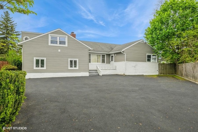 2600 Haff Ave, North Bellmore, NY 11710 - back of house featuring a chimney and driveway